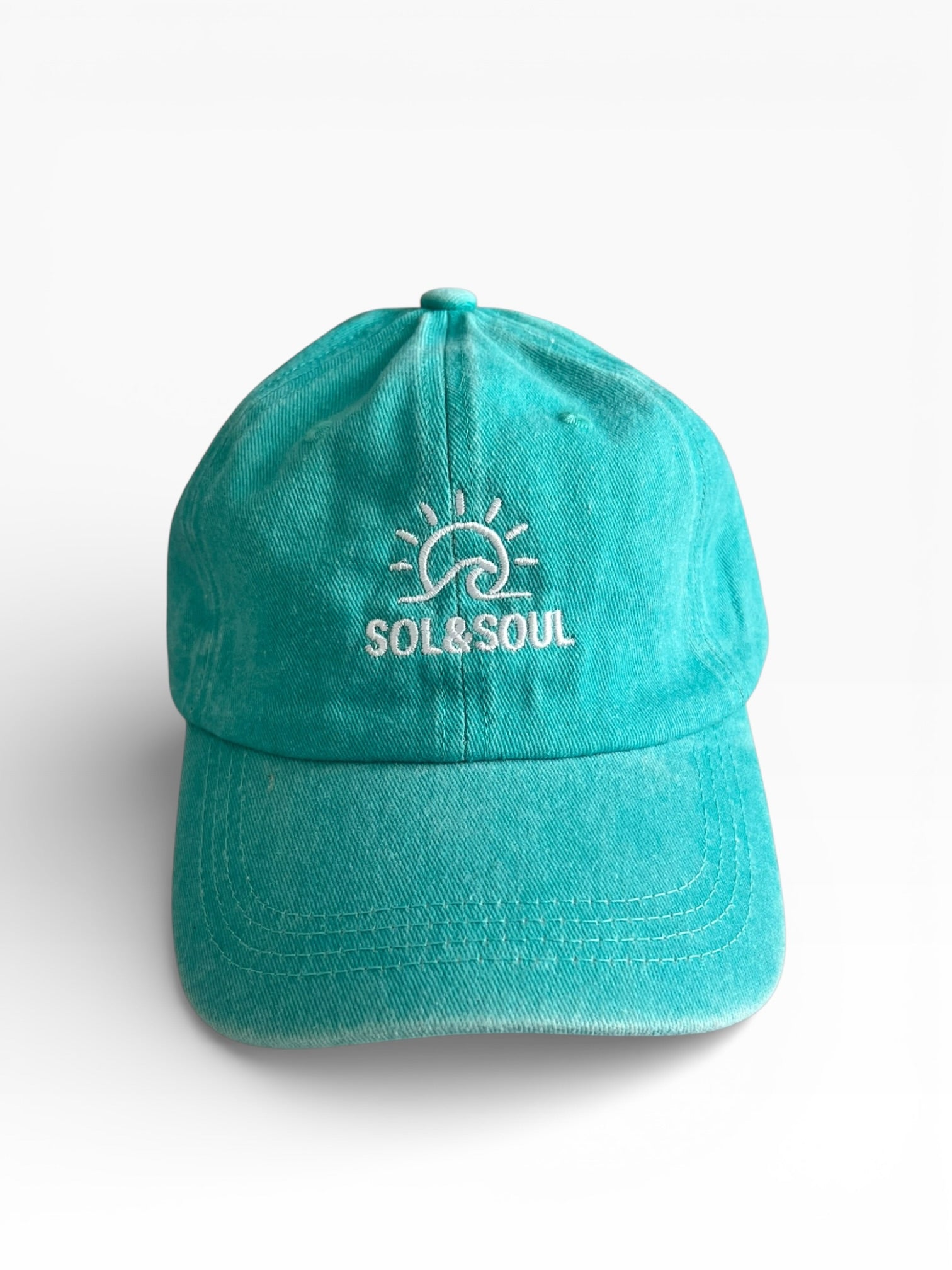 Teal cap with 'SOL & SOUL' logo on a white background